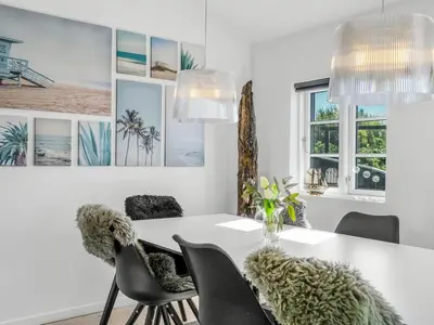 a dining room with a white table and chairs at Holiday Home Wiebke - 200m from the sea by Interhome in Blokhus