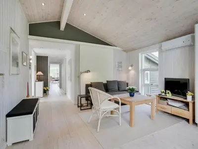 a living room with a table and a couch at Holiday Home Ninna - 1km from the sea by Interhome in Blokhus