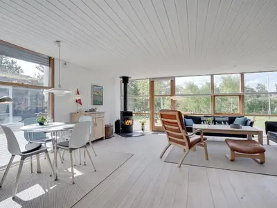 a living room with a table and chairs at Holiday Home Ninna - 1km from the sea by Interhome in Blokhus