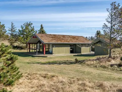 a house with a shingled roof at Holiday Home Alfrik - 900m from the sea by Interhome in Blokhus
