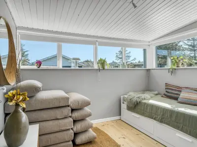 a white room with a bed and windows at Holiday Home Ozan - 400m from the sea by Interhome in Blokhus