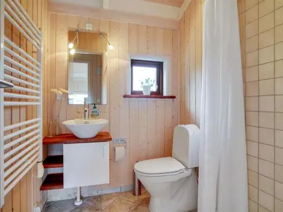 a bathroom with a toilet and a sink at Holiday Home Friderike - 200m from the sea by Interhome in Blokhus