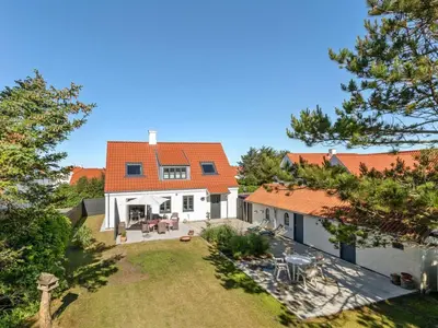 an aerial view of a white house with an orange roof at Holiday Home Shiva - 300m from the sea by Interhome in Blokhus