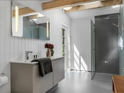 a bathroom with a sink and a shower at Holiday Home Ansberga - 1km from the sea by Interhome in Blokhus