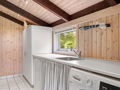a kitchen with a sink and a refrigerator at Holiday Home Ingimar - 2-2km from the sea by Interhome in Blokhus