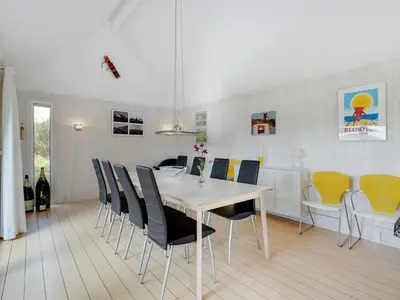 a dining room with a table and chairs at Holiday Home Henric - 100m from the sea by Interhome in Blokhus