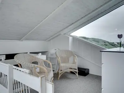 a balcony with two chairs and a table and a window at Holiday Home Swerting - 230m from the sea by Interhome in Saltum