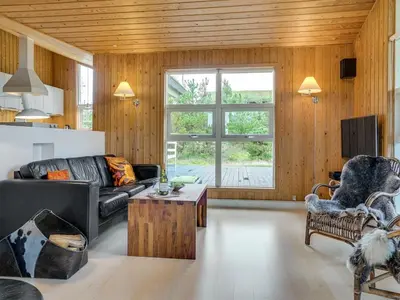 a living room with a couch and a table at Holiday Home Hereth - 700m from the sea by Interhome in Saltum