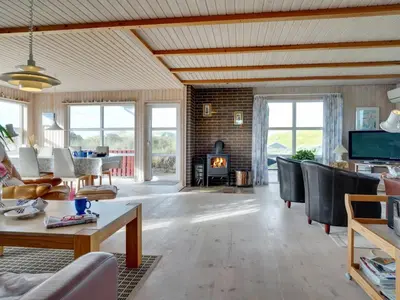 a living room filled with furniture and a fireplace at Holiday Home Dana - 290m from the sea by Interhome in Saltum