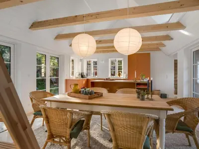 a kitchen and dining room with a table and chairs at Holiday Home Beghel - 350m from the sea by Interhome in Blokhus