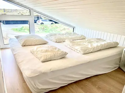 three pillows on a bed in a room at Holiday Home Nilson - 1-4km from the sea by Interhome in Blokhus