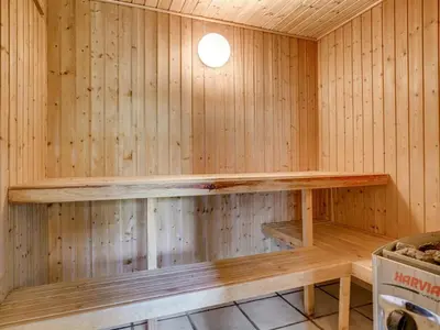 a sauna with a wooden shelf on the wall at Holiday Home Nilson - 1-4km from the sea by Interhome in Blokhus