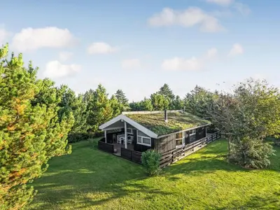 a log home with a grass roof at Holiday Home Barnet - 2-2km from the sea by Interhome in Blokhus