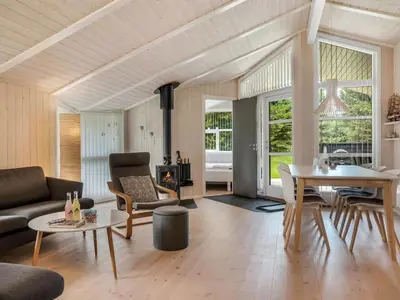 a living room with a couch and a table at Holiday Home Barnet - 2-2km from the sea by Interhome in Blokhus