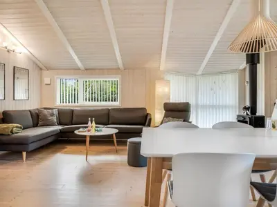 a living room with a couch and a table at Holiday Home Barnet - 2-2km from the sea by Interhome in Blokhus