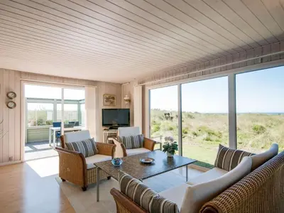 a living room with a couch and a table at Holiday Home Diuri - 400m from the sea by Interhome in Saltum