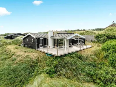 a tiny house on the side of a field at Holiday Home Josten - 500m from the sea by Interhome in Saltum
