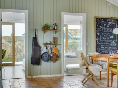 a dining room with a table and a chalkboard at Holiday Home Simeona - 140m from the sea by Interhome in Saltum