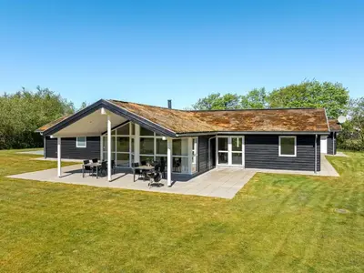 a house with a large backyard with a patio at Holiday Home Ricus - 1-8km from the sea by Interhome in Saltum