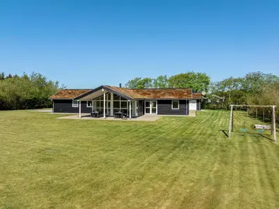 a house with a soccer field in front of it at Holiday Home Ricus - 1-8km from the sea by Interhome in Saltum