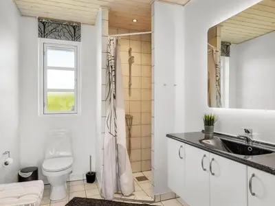 a bathroom with a toilet and a sink at Holiday Home Annemie - 1-8km from the sea by Interhome in Saltum