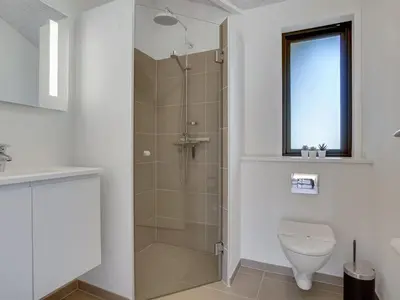 a bathroom with a shower and a toilet at Holiday Home Bentine - 1-6km from the sea by Interhome in Saltum