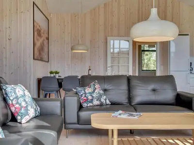 a living room with a couch and a table at Holiday Home Bentine - 1-6km from the sea by Interhome in Saltum