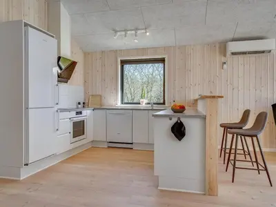 a kitchen with white appliances and a white refrigerator at Holiday Home Bentine - 1-6km from the sea by Interhome in Saltum