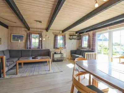 a living room with a couch and a table at Holiday Home Arita - 250m from the sea by Interhome in Saltum