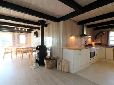 a kitchen and dining room with a table and chairs at Holiday Home Arita - 250m from the sea by Interhome in Saltum