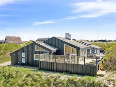 a black house on the beach at Holiday Home Dijana - 150m from the sea by Interhome in Saltum