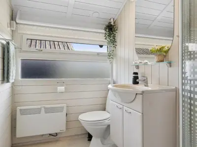 a small bathroom with a toilet and a sink at Holiday Home Allida - 800m from the sea by Interhome in Saltum