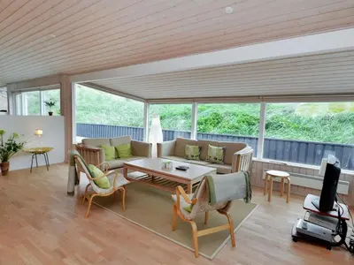 a living room with a couch and a table at Holiday Home Hadar - 100m from the sea by Interhome in Saltum