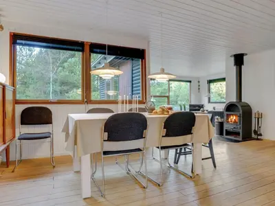 a kitchen and dining room with a table and chairs at Holiday Home Antoinetta - 900m from the sea by Interhome in Saltum