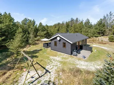 an aerial view of a tiny house in the woods at Holiday Home Antoinetta - 900m from the sea by Interhome in Saltum
