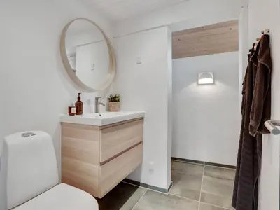 a bathroom with a sink and a mirror at Holiday Home Kadife - 750m from the sea by Interhome in Saltum