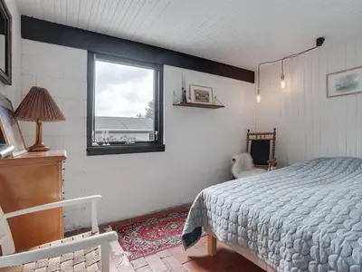 a bedroom with a bed and a window at Holiday Home Kadife - 750m from the sea by Interhome in Saltum