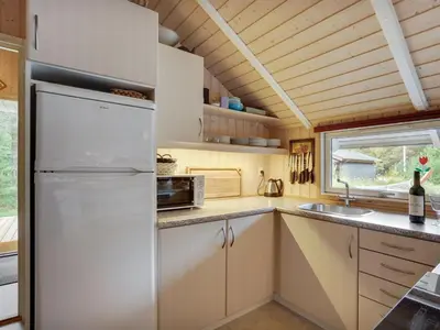 a kitchen with a refrigerator and a sink at Holiday Home Varpu - 1-6km from the sea by Interhome in Saltum