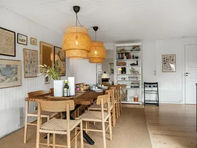 a dining room with a table and chairs at Holiday Home Ayelen - 600m from the sea by Interhome in Saltum