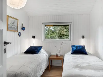 two beds in a room with a window at Holiday Home Ayelen - 600m from the sea by Interhome in Saltum