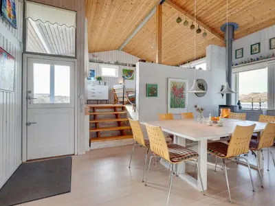 a kitchen and dining room with a table and chairs at Holiday Home Kulle - 200m from the sea by Interhome in Saltum