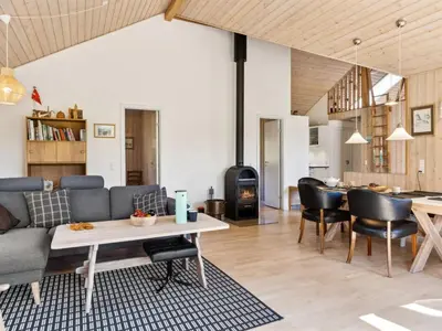 a living room with a couch and a table at Holiday Home Swen - 1-3km from the sea by Interhome in Saltum