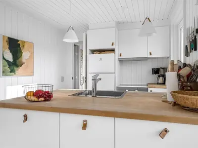 a kitchen with a sink and a bowl of fruit on the counter at Holiday Home Asser - 400m from the sea by Interhome in Saltum