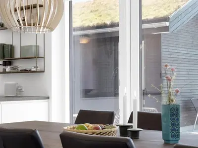 a dining room table with a bowl of fruit on it at Holiday Home Fredrika - 1-5km from the sea by Interhome in Saltum