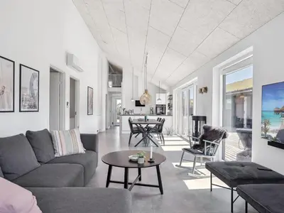 a living room with a couch and a table at Holiday Home Fredrika - 1-5km from the sea by Interhome in Saltum