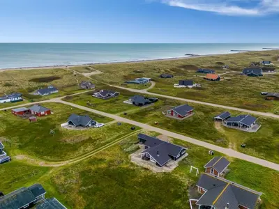 an aerial view of a group of houses on the beach at Holiday Home Sochyeta - 150m from the sea by Interhome in Harboør