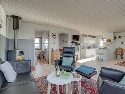 a living room with a couch and chairs and a table at Holiday Home Soyala - 400m from the sea by Interhome in Harboør