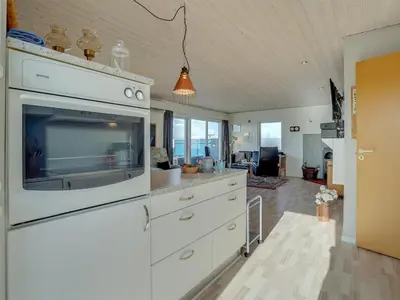 a kitchen with white cabinets and a large appliance at Holiday Home Soyala - 400m from the sea by Interhome in Harboør