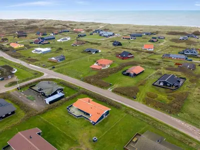 an aerial view of a subdivision with houses and the ocean at Holiday Home Odmar - 300m from the sea by Interhome in Harboør