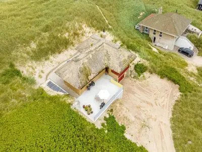 an aerial view of a house on a beach at Holiday Home Zora - 100m from the sea by Interhome in Harboør